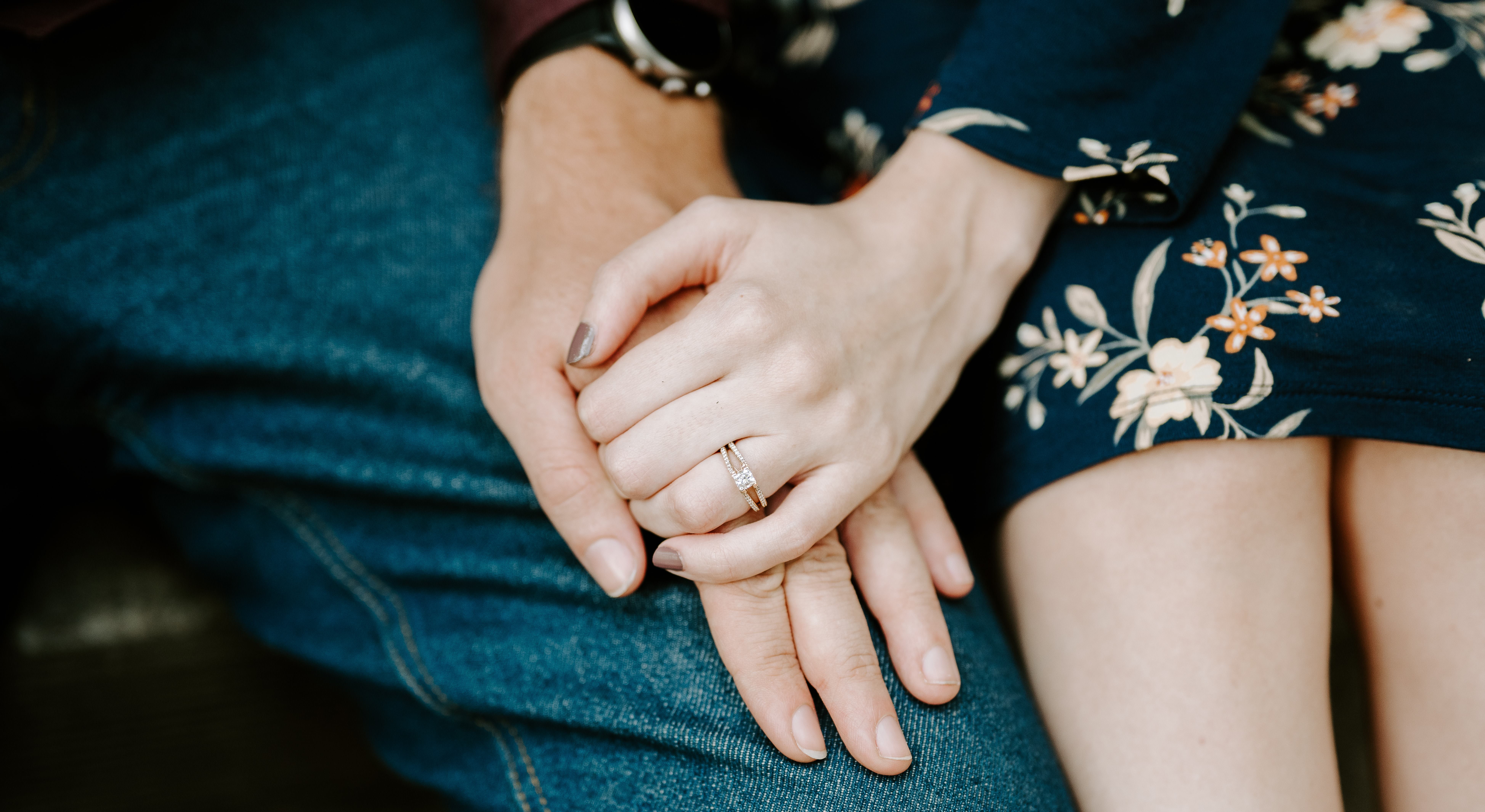 Matthew & Samantha holding hands, highlighting the engagement ring